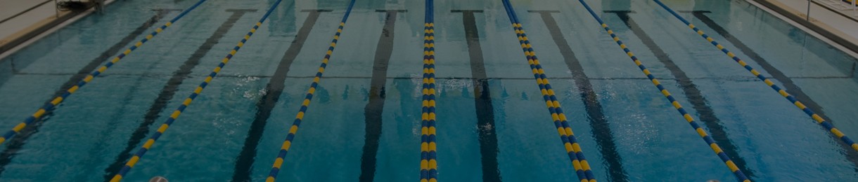 A swimming pool with two lanes and blue water.